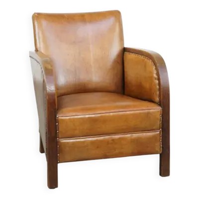 Fauteuil design Art Déco en peau de mouton couleur cognac et bois